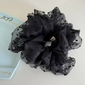 Detail of black organza scrunchie with 3D flocked dots and Hand Made woven label