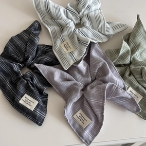 Striped cotton fabric scrunchies in four pastel colors with letter patch labels