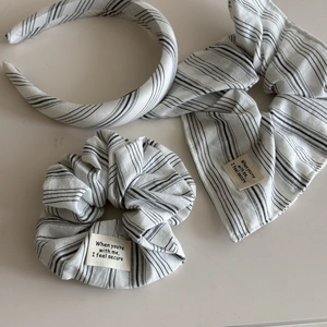 Detail showing striped fabric hair set with headband, scrunchie and ribbon tie