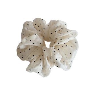 Elegant white polka dot mesh scrunchie with a lightweight sheer texture and black dots