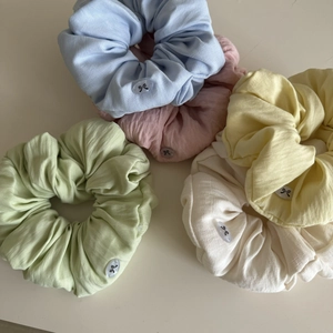 Set of 5 pastel cotton scrunchies with elegant bow accents on a minimalist background