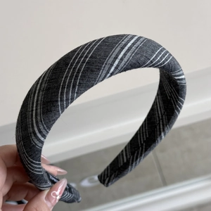 Macro detail of dark grey striped padded headband with soft cotton blend texture