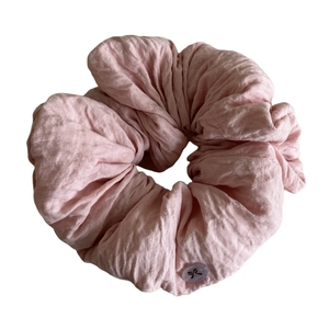 Pink puffy fabric scrunchie with cute butterfly button detail on clean white background