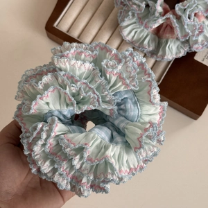Detail view of large checkered scrunchies with wavy scalloped edge embroidery