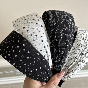 Fashionable wide pleated headbands featuring black and white floral and star patterns