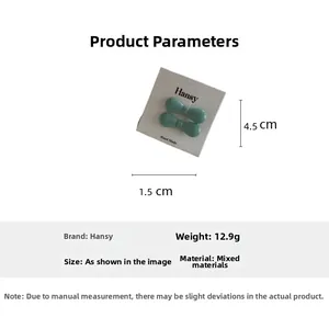 Detail view of turquoise mini bow hair clips on a white display card with measurements
