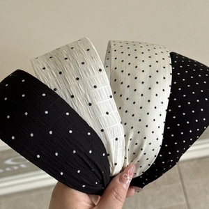 Set of four wide black and white polka dot headbands with textured fabric for women