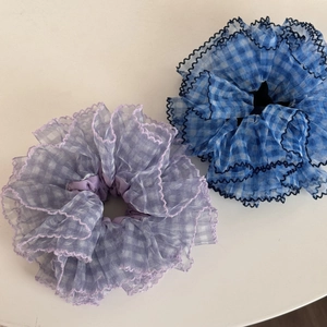 Macro detail of large mesh scrunchies featuring blue plaid and purple lace edge design