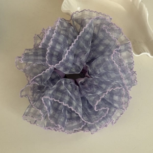 Detailed close-up of purple lace scrunchie with layered mesh ruffles and plaid pattern