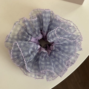 Detailed view of large purple pleated mesh scrunchie with wave-stitched edge texture