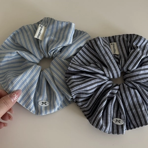 Blue and white striped fabric scrunchie with Happiness label and bow detail charm