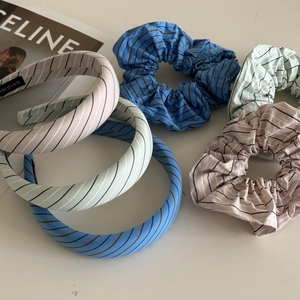 Detailed set of striped pastel headbands and hair scrunchies in pink, mint green and blue