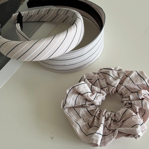 Detailed view of pink and black striped headband and scrunchie set in soft cotton fabric