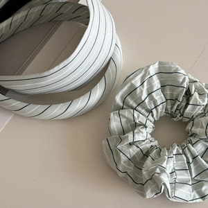 Detailed view of mint green striped cotton headband and matching scrunchie set