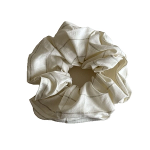 Elegant beige striped scrunchie hair tie with detailed fabric texture on white background