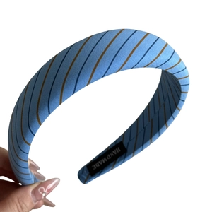 Handmade light blue striped fabric headband with deep blue and brown diagonal patterns