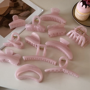 Flat lay of pink jelly hair claws with pearlescent shimmer in various elegant shapes
