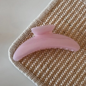 Macro shot of pink glitter hair claw clip with a glossy translucent jelly texture