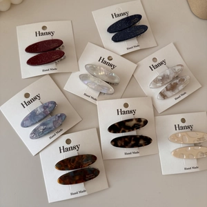 Set di due fermagli per capelli ovali in acetato con motivi tartarugati e glitter