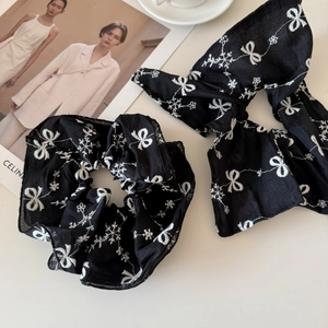 Detail of black scrunchie and bow set with white butterfly embroidery and soft texture