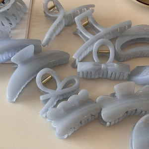 Detail view of assorted light blue marble hair claws with shimmering jelly texture
