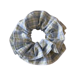 Pastel blue and green plaid fabric scrunchie with fluffy gingham checkered texture