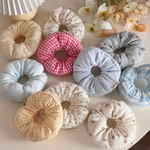 Detailed view of 10-piece floral and plaid fabric scrunchies in various colorful patterns