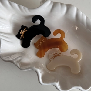 Three cute acetate cat hair clips in black, amber, and cream with gold whiskers for women