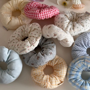 Floral and plaid fabric scrunchies in various soft cotton patterns for girls' hairstyling