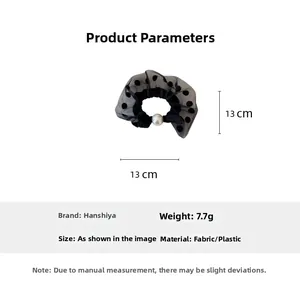 Detail view of black mesh polka dot hair scrunchie with large pearl bead, 13cm diameter