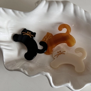 Three-piece set of cute cat acetate hair clips in black, amber, and creamy white colors