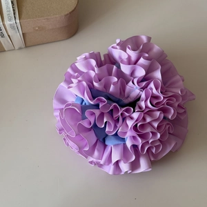 Detail view of purple and blue layered ruffle scrunchie with handmade pleated texture