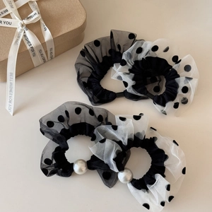 Detail of mesh polka dot scrunchies set with faux pearls and gift box scene