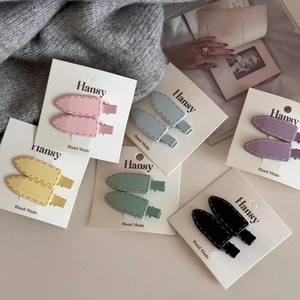 Detailed view of candy-colored Korean snap clips on a display card with various shades