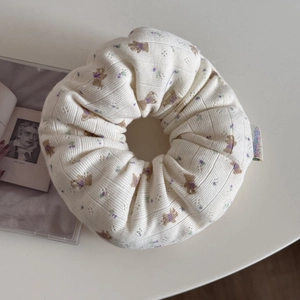 Detail of oversized floral hair scrunchie with cute bear pattern and lace edge trim