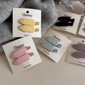 Colorful candy-colored duckbill hair clips for kids with decorative stitching details