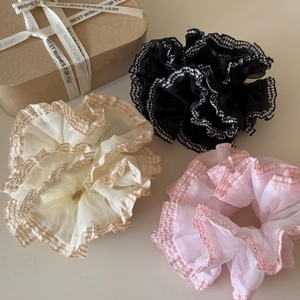 Detailed close-up of plaid lace organza scrunchies in beige, black and pink colors