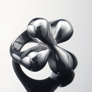 Modern black polished stainless steel ring with a unique four-lobed flower-like design