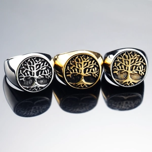 Three men's stainless steel Tree of Life rings in silver, gold and black bi-color