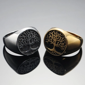 Macro shot of silver and gold tree of life signet rings with detailed mirror reflection