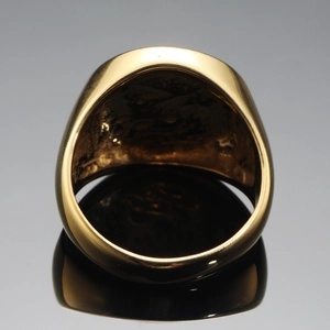 Macro detail of the Tree of Life signet ring in polished golden stainless steel