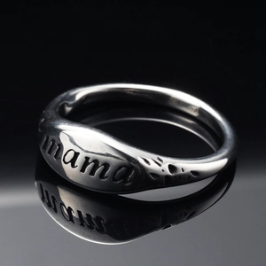 Silver stainless steel ring with mama engraving and irregular hammered texture on black background