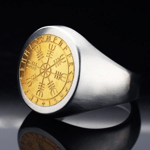 Close-up of Viking compass Vegvisir and runes engraved on a brushed steel ring