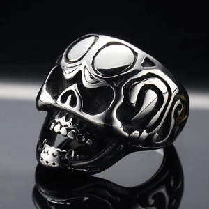 Gothic skull stainless steel open ring with engraved patterns on a reflective surface