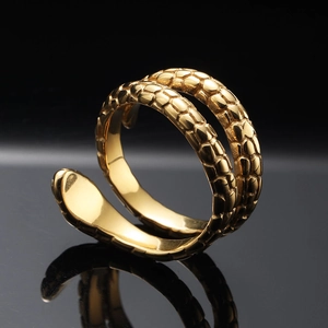 Macro shot of golden snake ring with detailed scales and a polished inner surface
