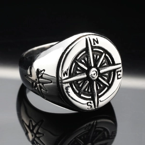 Vintage stainless steel compass signet ring for men with nautical star engraving on black background