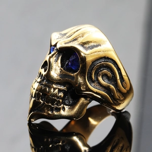 Punk style skull ring in antique bronze with blue crystal eyes and textured detailing