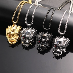 Macro detail of Hannya Oni mask pendants in four metallic finishes with red rhinestone eyes