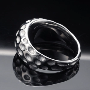 Minimalist wide geometric stainless steel ring with hammered texture on dark mirror surface