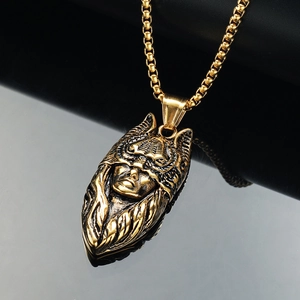 Detail of vintage catwoman mask pendant with antique gold finish on a round box chain